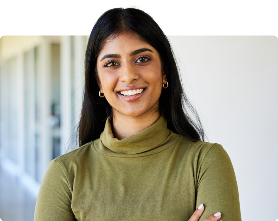 A portrait of a smiling woman who increased her financial security with the help of GuidePlan's automated financial wellness programs.